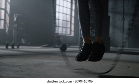 Unrecognizable Female Athlete Legs Jumping On Skipping Rope In Gym. Closeup Athletic Woman Feet Jumping With Jump Rope. Active Girl In Sneakers Training At Sport Club