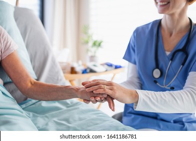 Unrecognizable female doctor examining patient in bed in hospital. - Shutterstock ID 1641186781