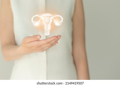 Unrecognizable female patient in white clothes, highlighted handrawn uterus in hands. Human reproductive system issues concept. - Shutterstock ID 2149419507