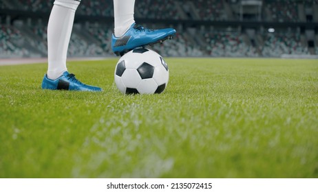 Unrecognizable female standing with soccer ball on side of a field of a huge stadium - Powered by Shutterstock