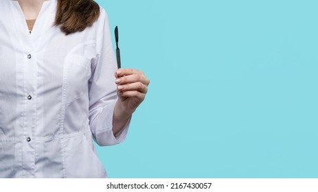 Unrecognizable Female Surgeon Holding Metal Non-sterile Surgical Instrument. Doctor Demonstrates How To Properly Hold Scalpel. Close Up. Tutorial