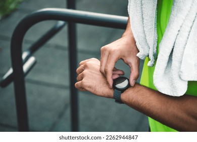 Unrecognizable fit man checking his smart watch after cardio - Powered by Shutterstock