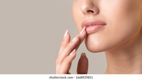 Unrecognizable Girl Touching Lips Posing Over Beige Studio Background. Natural Makeup Concept. Panorama, Cropped, Copy Space