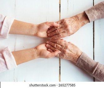 Unrecognizable grandmother and her granddaughter holding hands. - Powered by Shutterstock