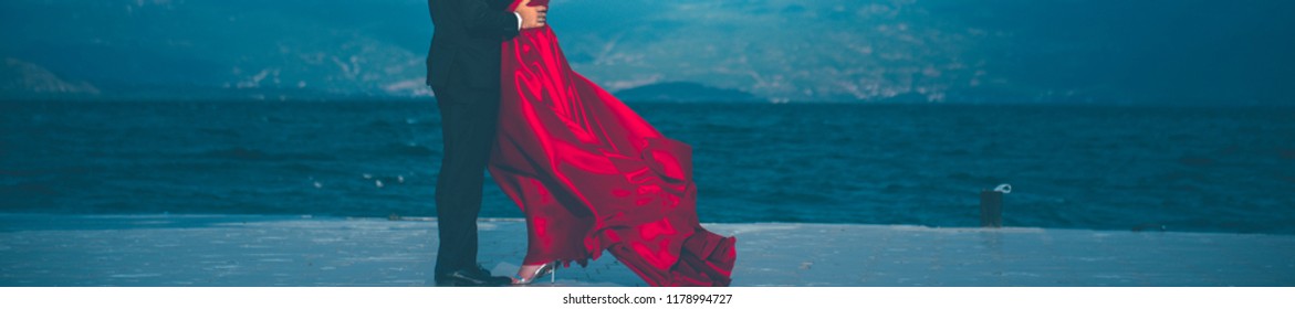 Unrecognizable Groom And Bride In Red Satin Dress Posing