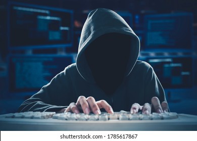 Unrecognizable Hacker Typing On The Computer Keyboard With Coding Background