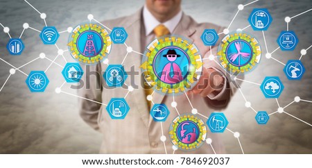 Unrecognizable inside corporate operator launching a cyber-attack on critical energy infrastructure systems. Computer security concept for white collar crime and cyber terrorism in the energy sector.