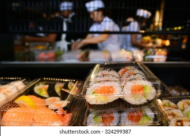 Unrecognizable Japanese Kitchen Workers Preparing Sushi Rolls In A Sushi Bar Restaurant  In Tokyo, Japan.