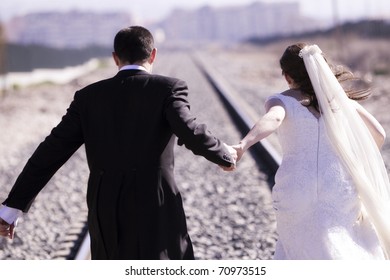 Unrecognizable Just Married Couple Running Away