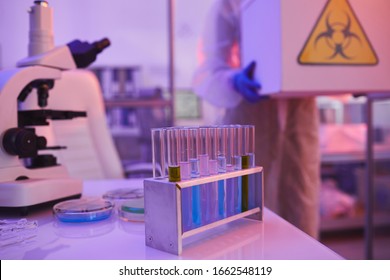 Unrecognizable laboratory worker bringing hazardous chemical materials into laboratory room, copy space