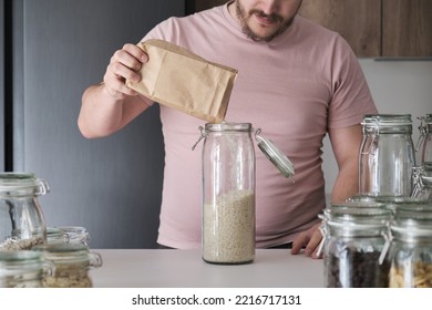 Unrecognizable Latin Man Filling Up A Jar With Basmati Rice From A Paper Bag. Food In Bulk Delivery.