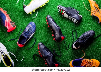 Unrecognizable little football player against green grass, studi - Powered by Shutterstock