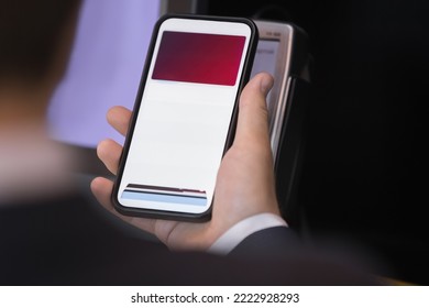 Unrecognizable male client buy goods, makes easy, quick payment use smart phone lean to card reader machine, close up. Purchases using modern NFC technology, cashless, contactless pay in retail place