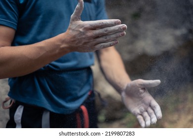 Unrecognizable Male Climber Put Climbing Chalk On Hands In Order To Improve Friction And Grip