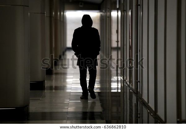 Unrecognizable male figure with hidden face in hood\
walking in dark hall, looking dangerous, stalking night robber\
burglar, bad troubled period, hooded guy feeling lost and\
abandoned, becoming ghost \
