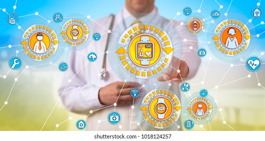 Unrecognizable Male Physician Is Tracking The Pulse Trace Of A Remote Worker Via Smart Watch. Healthcare Concept For Internet Of Medical Things, IoMT, Internet Of Things, IoT, Wearable Technology.