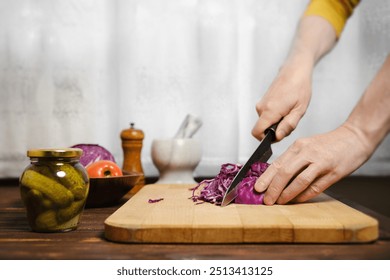 Unrecognizable man cutting red cabbage in the kitchen - Powered by Shutterstock