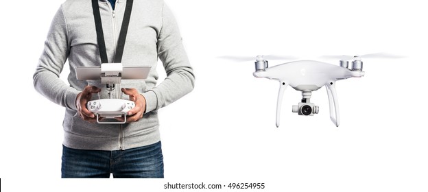 Unrecognizable man with flying drone. Studio shot, isolated.