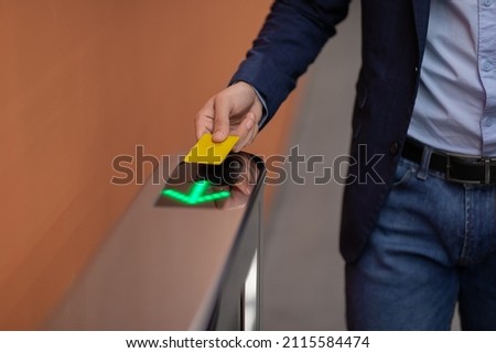 Unrecognizable man in formal outfit holding Electronic entrance gate card, cropped of worker passing access building security system at office, panorama with copy space, closeup