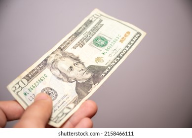 Unrecognizable Man Hand Holding US Dollar Bill Of 20  Twenty Dollars Banknote