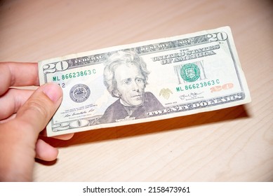 Unrecognizable Man Hand Holding US Dollar Bill Of 20  Twenty Dollars Banknote