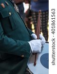 Unrecognizable man marching while playing drum