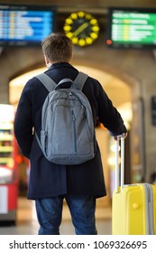 Unrecognizable Man On Railroad Station Platform Looking On Information Display. Travel, Tourism, Vacation And Buisness Trip Concept.