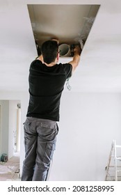 Unrecognizable Man Preparing Extractor Hood Installation On Kitchen Ceiling