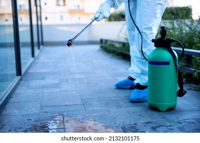 Unrecognizable Man Spraying Sanitizer Disinfecting And Rodent Control Outdoor. Infection Prevention, Control Diseases Spreading And Insect Extermination. Copy Space 