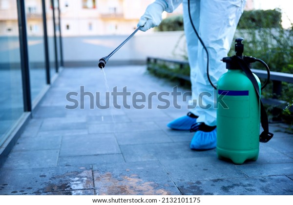 Unrecognizable Man Spraying\
sanitizer disinfecting and rodent control outdoor. Infection\
prevention, control diseases spreading and insect extermination.\
Copy space 