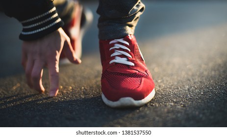 Unrecognizable man stopping lacing shoe outdoors. Athletic shoes concept. Jogging in the park - Shutterstock ID 1381537550
