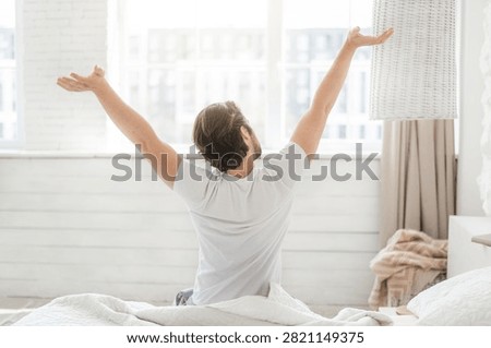Unrecognizable Man Stretching In Bed During Morning, Relaxed Atmosphere, Bedroom Interior
