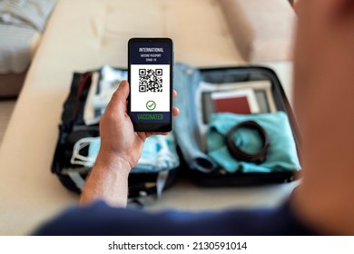 Unrecognizable man using digital passport app on mobile for travel during COVID-19. Preparing for travel. Digital vaccine passport. International certificate of vaccination for coronavirus on mobile. - Powered by Shutterstock