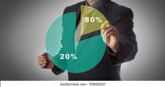 Unrecognizable manager with marker in hand approaching virtual pie chart illustrating the Pareto principle. Business concept for 80 - 20 rule, law of the vital few and principle of factor sparsity.