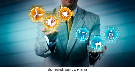 Unrecognizable Manager Raising Renewable Energy Sector Icons Above Fossil Fuel Symbols. Industry, Business And Technology Metaphor For Transition To Alternative Power Generation, Sustainability.