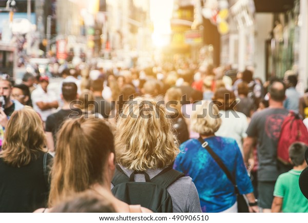 Unrecognizable mass of\
people walking in the\
city