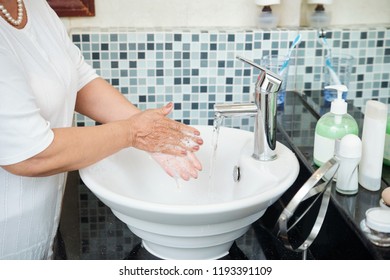 Unrecognizable Mature Woman Washing Hands With Soap Thoroughly While Standing By Sink In Modern Bathroom