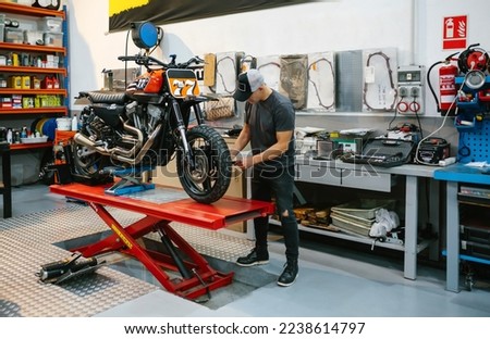 Similar – Image, Stock Photo Retro motorbike on platform lift in workshop