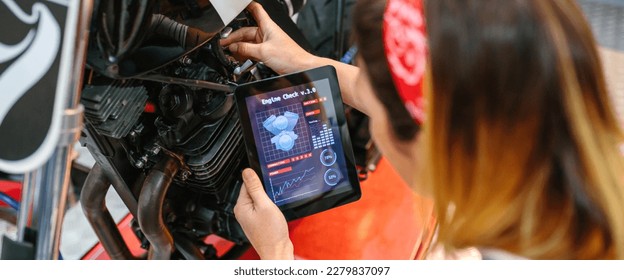 Unrecognizable mechanic woman using a engine diagnosis app in digital tablet to review motorcycle on factory - Powered by Shutterstock