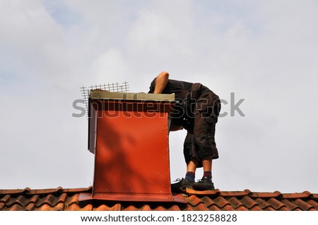Unrecognizable modern chimney sweep checking out the chimney from the inside to see if it needs repair. 
