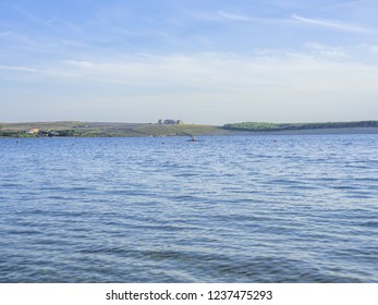 Unrecognizable Older Man Rowing Kayak In The Sea At Beautiful Sunny Evening.