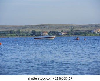 Unrecognizable Older Man Rowing Kayak In The Sea At Beautiful Sunny Evening.