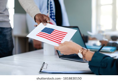 Unrecognizable people with face mask voting in polling place, usa elections and coronavirus. - Shutterstock ID 1818830150