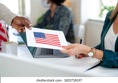 Unrecognizable people with face mask voting in polling place, usa elections. - Shutterstock ID 1823718197