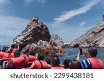 Unrecognizable people on boat sightseeing in the Ballestas Islands at Paracas, Ica Peru
