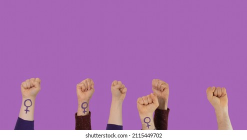 Unrecognizable people raising their fist for Women's Day on a purple background. - Powered by Shutterstock