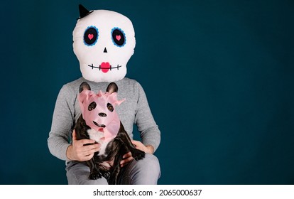 Unrecognizable Person And French Bulldog With Halloween Masks