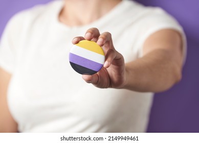 Unrecognizable Person Showing To The Camera A Non Binary Flag Badge Or Pin. Concepts Of Identity Pride, Gender Diversity, Equality And Non Discrimination.