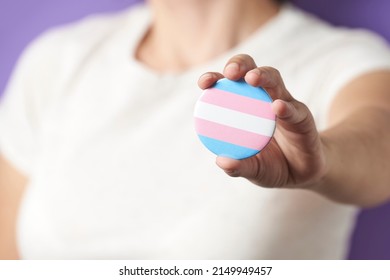 Unrecognizable Person Showing To The Camera A Trans Flag Badge Or Pin. Concepts Of Identity Pride, Gender Diversity, Equality And Non Discrimination.