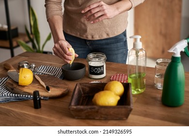 Unrecognizable Person Squeezing Lemon Juice To The Bowl With DIY Cleaning Product